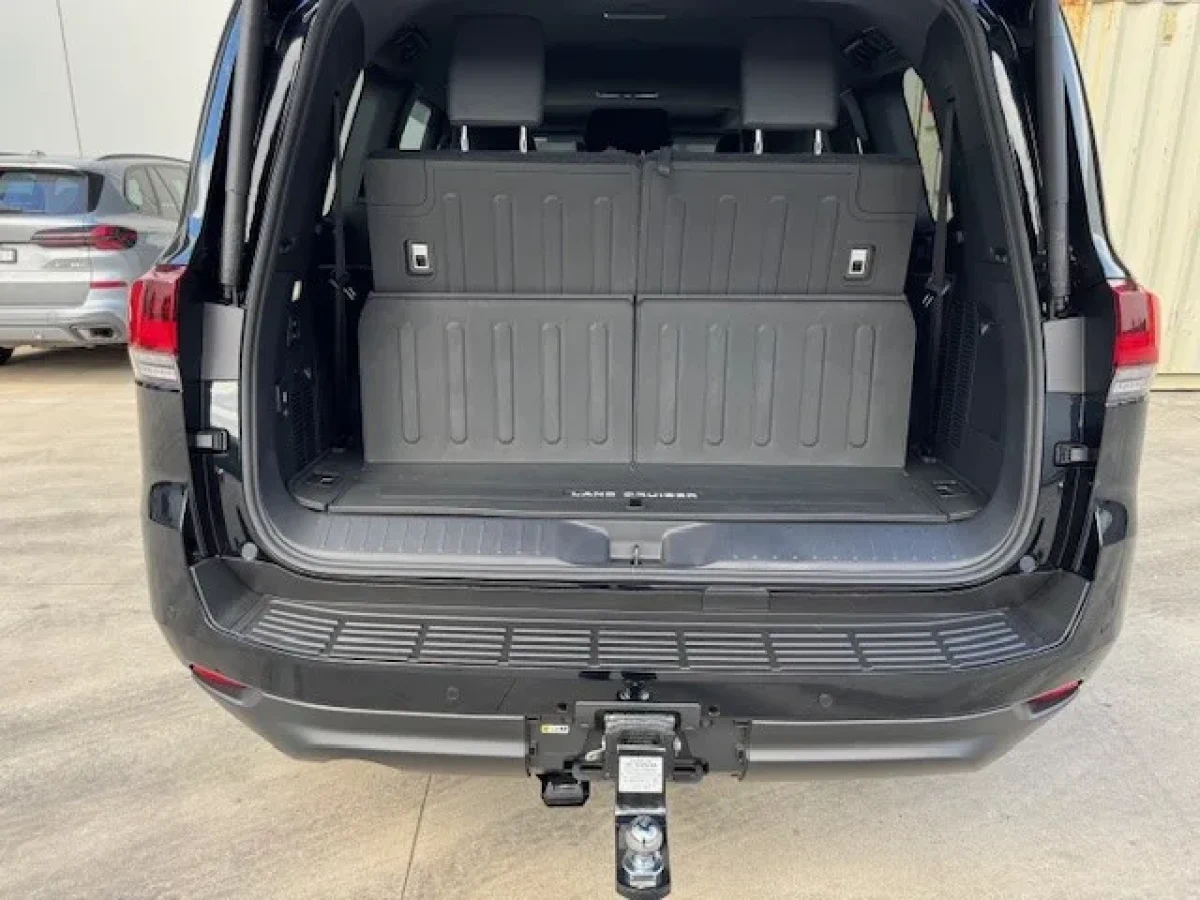 Open cargo area of the dark Land Cruiser Sahara LC300