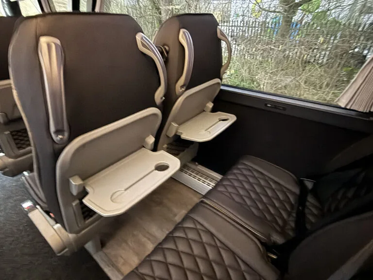 Passenger seats with seat-back tables inside the AOS Visigo