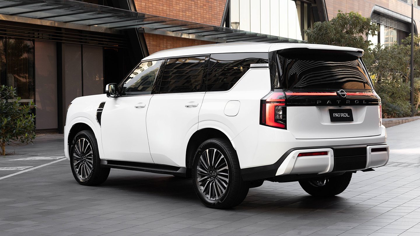 Rear three-quarter view of a white all-new Nissan Patrol in official urban imagery